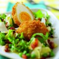 Deep fried egg with pea, bacon & chicory salad