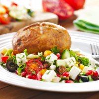 Baked potato with feta and pomegranate