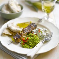 Grilled lamb skewers with crushed peas, tzatziki & chilli