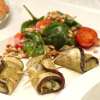 Aubergine, pesto & mozzarella rolls with spinach & pinenut salad